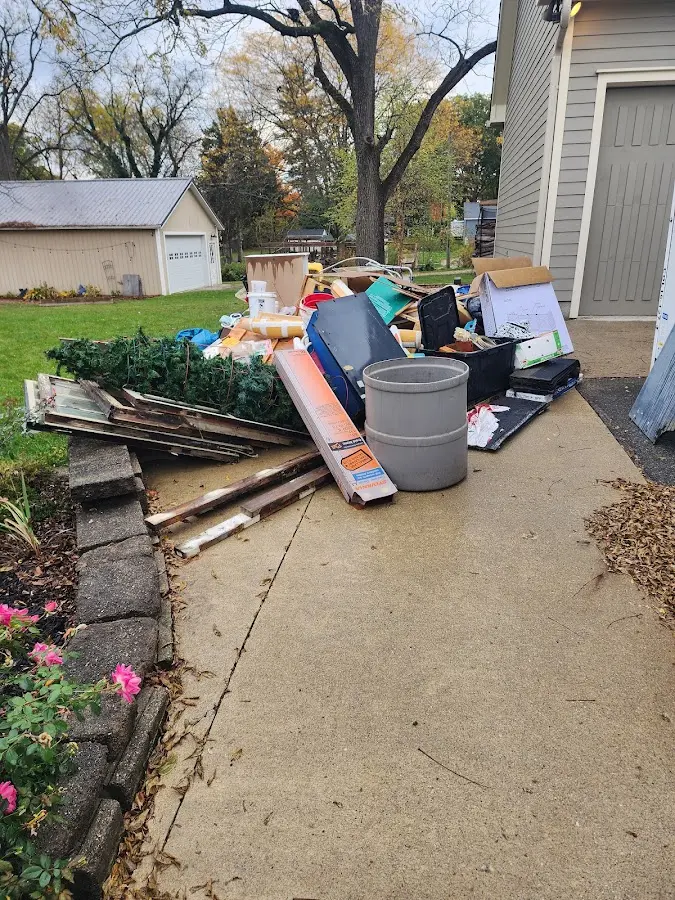 Dumpster being loaded with debris for 30 Yard Dumpster Rental in East Greenwich